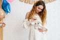 Happy young pregnant woman holding small baby shoes Royalty Free Stock Photo