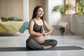 Happy young pregnant woman training yoga in lotus pose at home Royalty Free Stock Photo