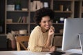 Happy young pretty African American businesswoman working on computer. Royalty Free Stock Photo