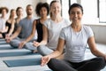 Happy young pretty indian ethnicity woman sitting in lotus pose.