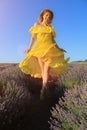 Happy young pretty woman jumps from happiness at sunset in a lavender field. The concept of freedom and positive Royalty Free Stock Photo