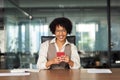 Happy young professional African American business woman using phone in office. Royalty Free Stock Photo