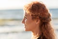 Happy young redhead woman face on beach Royalty Free Stock Photo