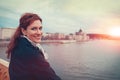 Happy young redhead woman looking back at Budapest cityscape in Royalty Free Stock Photo