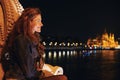 Happy young redhead woman wondering in Budapest night panorama Royalty Free Stock Photo