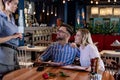 Young romantic couple ordering dinner together in a restaurant. Royalty Free Stock Photo