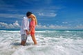 Happy young romantic couple standing on the beach and kissing ea Royalty Free Stock Photo