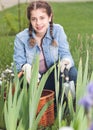 happy young brunette girl with basket gardening in summer park