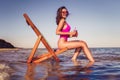 Happy young sexy woman in pink bikini posing with coctail on lounger beach. summer vacation concept Royalty Free Stock Photo