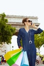 Happy young shopper woman with shopping bags using mobile phone Royalty Free Stock Photo