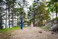 Happy young single father taking a walk in a park with his toddler daughter. Family laughing and having fun