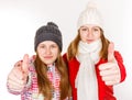 Happy young sisters showing thumbs up Royalty Free Stock Photo