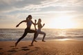 Happy young slim european women twins in sportswear run at morning, freeze in air at sea beach, outdoor