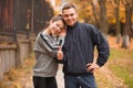 Happy sporty couple gently hugging in the autumn park. Royalty Free Stock Photo