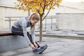 Happy young sporty woman tying shoelaces outdoors Royalty Free Stock Photo