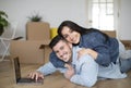 Happy Young Spouses Embracing And Using Laptop After Moving To Their New Home, Royalty Free Stock Photo