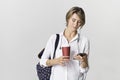 Happy young student girl with backpack using smart phone Royalty Free Stock Photo