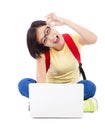 Happy young student girl sitting on floor with a laptop Royalty Free Stock Photo