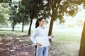 Happy young student woman holding laptop computer at public park in the morning,Happy and smiling,Relax time Royalty Free Stock Photo