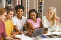 Happy young students working on project at library Royalty Free Stock Photo