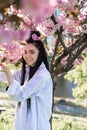 beautiful young teen girl in spring blooming cherry blossoms garden Royalty Free Stock Photo