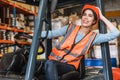happy young teen warehouse staff worker enjoy smiling at forklift driver for control loading factory inventory shipping products Royalty Free Stock Photo
