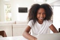 Happy young teenage African American  girl using laptop computer at home, close up Royalty Free Stock Photo