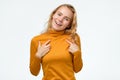 Happy young teenager woman pointing fingers at herself. Royalty Free Stock Photo