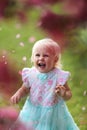 Happy Young Toddler Girl Laughing as Flower Petals Fall Off a Cr Royalty Free Stock Photo