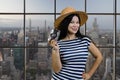 Happy young tourist asian woman is holding a vintage photo camera. Royalty Free Stock Photo