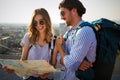 Happy tourist couple, friends sightseeing city with map. Travel people vacation concept Royalty Free Stock Photo