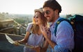 Happy tourist couple, friends sightseeing city with map. Travel people vacation concept Royalty Free Stock Photo