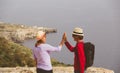 Happy young tourist couple hiking in mountains Royalty Free Stock Photo