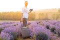 Happy young tourist man holding passport in lavender field Royalty Free Stock Photo