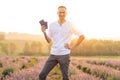 Happy young tourist man holding passport in lavender field Royalty Free Stock Photo