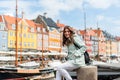 Happy young tourist woman with backpack at Copenhagen Royalty Free Stock Photo