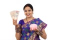 Happy young traditional woman holding Indian currency Royalty Free Stock Photo