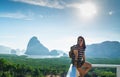 Happy young traveler woman backpacker sitting at mountain panorama view point and sea and enjoying a beautiful of nature Royalty Free Stock Photo