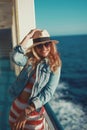 Happy traveler woman in hat toothy smile on cruise ship