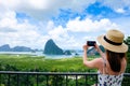 Happy Young Traveler Woman Raised Arm take a photo To Sky