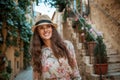 Happy traveller woman in old Europe town having walking tour