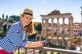 Happy young traveller woman in Rome, Italy viewing photos