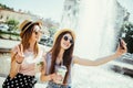 Technology, lifestyle and people concept - happy young two friends women taking selfie by smartphone and drinking cocktails drinks Royalty Free Stock Photo