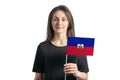 Happy young white girl holding Haiti flag isolated on a white background