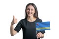 Happy young white woman holding flag of Aruba and shows the class by hand isolated on a white background