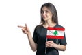 Happy young white woman holding flag Lebanon and points to the left isolated on a white background