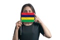 Happy young white woman holding flag Mauritius flag and covers her face with it isolated on a white background