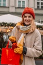 Stylish young beautiful happy woman walk with shopping bags and gift boxes on city street. Cheerful attractive girl Royalty Free Stock Photo