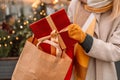 Stylish young beautiful happy woman walk with shopping bags and gift boxes on city street. Cheerful attractive girl Royalty Free Stock Photo