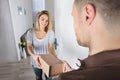 Delivery Man Giving Parcel Box To Young Woman Royalty Free Stock Photo